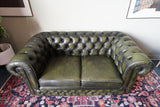 Vintage olive green leather Chesterfield two seater club sofa with deep buttoning and scroll arms