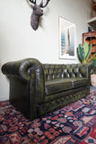 Vintage olive green leather Chesterfield two seater club sofa with deep buttoning and scroll arms