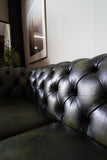 Vintage olive green leather Chesterfield two seater club sofa with deep buttoning and scroll arms