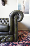 Vintage olive green leather Chesterfield two seater club sofa with deep buttoning and scroll arms