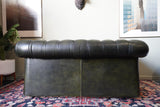 Vintage olive green leather Chesterfield two seater club sofa with deep buttoning and scroll arms