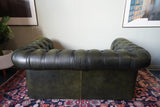 Vintage olive green leather Chesterfield two seater club sofa with deep buttoning and scroll arms