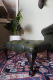 Vintage Chesterfield deep buttoned footstool in antiqued olive green leather with hardwood legs