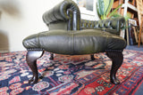Vintage Chesterfield deep buttoned footstool in antiqued olive green leather with hardwood legs