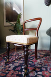 Victorian mahogany balloon back chair with brass castors and newly reupholstered patterned seat