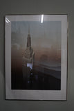 Pair of large framed architectural prints by Richard Davies depicting the Chrysler Building and Empire State Building mounted on wall