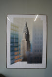 Pair of large framed architectural prints by Richard Davies depicting the Chrysler Building and Empire State Building mounted on wall