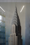 Pair of large framed architectural prints by Richard Davies depicting the Chrysler Building and Empire State Building mounted on wall