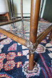 Pair of vintage 1970s bamboo and glass two-tier side tables set on a patterned rug