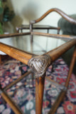Pair of vintage 1970s bamboo and glass two-tier side tables set on a patterned rug