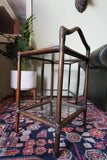 Pair of vintage 1970s bamboo and glass two-tier side tables set on a patterned rug
