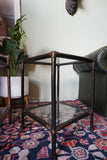 Pair of vintage 1970s bamboo and glass two-tier side tables set on a patterned rug