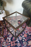 Pair of vintage 1970s bamboo and glass two-tier side tables set on a patterned rug