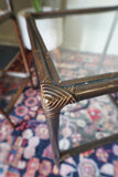 Pair of vintage 1970s bamboo and glass two-tier side tables set on a patterned rug