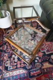 Pair of vintage 1970s bamboo and glass two-tier side tables set on a patterned rug