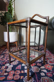 Pair of vintage 1970s bamboo and glass two-tier side tables set on a patterned rug